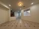 Open living room with tiled flooring, with a view of the kitchen in the background at 6546 Churnet Valley Ave, Las Vegas, NV 89139