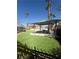 Relaxing pool area with shaded pergola, manicured lawn, and palm trees at 6546 Churnet Valley Ave, Las Vegas, NV 89139