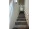 Carpeted stairway with a white handrail leads to the upper level of the home at 6546 Churnet Valley Ave, Las Vegas, NV 89139