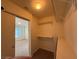 Neutral walk-in closet with shelving and a view to the bedroom with carpeted floor at 6546 Churnet Valley Ave, Las Vegas, NV 89139