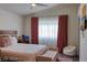 Bedroom features a large bed with a tufted bench and a ceiling fan at 725 Wheat Ridge Ln # 201, Las Vegas, NV 89145
