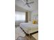 Bright bedroom featuring a tufted headboard, white linens, wood flooring, and natural light at 725 Wheat Ridge Ln # 201, Las Vegas, NV 89145