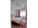 Bedroom features a large bed with a tufted bench, ceiling fan and natural light at 725 Wheat Ridge Ln # 201, Las Vegas, NV 89145