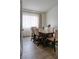 Dining room featuring wood flooring, a six-chair dining set and a window with light-filtering curtains at 725 Wheat Ridge Ln # 201, Las Vegas, NV 89145