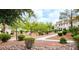 Townhouse community with manicured landscaping, walking paths, and mature trees at 725 Wheat Ridge Ln # 201, Las Vegas, NV 89145
