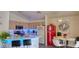 Kitchen featuring an island with blue lighting, a red refrigerator and a quaint dining area at 725 Wheat Ridge Ln # 201, Las Vegas, NV 89145