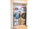 Stacked stainless steel washer and dryer with storage space in closet at 725 Wheat Ridge Ln # 201, Las Vegas, NV 89145