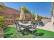 Relaxing backyard featuring a dining area, lounge chairs, landscaped garden, and a private pool at 7349 Merimack Oaks St, Las Vegas, NV 89166