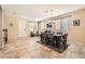 Bright dining room with tile flooring and chandelier, adjacent to the entry and living areas at 7349 Merimack Oaks St, Las Vegas, NV 89166