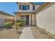 Inviting front entrance with a covered porch and well-maintained desert landscaping at 7349 Merimack Oaks St, Las Vegas, NV 89166