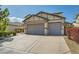 Spacious three car garage with large driveway and low maintenance desert landscaping at 7349 Merimack Oaks St, Las Vegas, NV 89166