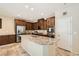Modern kitchen with granite countertops, island sink, stainless steel appliances, and ample cabinet space at 7349 Merimack Oaks St, Las Vegas, NV 89166