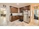Efficient kitchen featuring stainless steel appliances, ample cabinet space, and tile flooring at 7349 Merimack Oaks St, Las Vegas, NV 89166