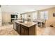Spacious kitchen with island sink, granite counters, and view of the living area and dining nook at 7349 Merimack Oaks St, Las Vegas, NV 89166