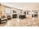 Open-concept living room with neutral tones, tile flooring, and abundant natural light at 7349 Merimack Oaks St, Las Vegas, NV 89166