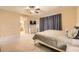 Comfortable primary bedroom featuring carpet flooring, ceiling fan, and en-suite bathroom entrance at 7349 Merimack Oaks St, Las Vegas, NV 89166