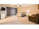Expansive primary bedroom featuring a ceiling fan, carpet flooring, and a cozy seating area at 7349 Merimack Oaks St, Las Vegas, NV 89166