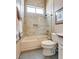 Bright bathroom showcasing tiled shower and tub combo behind clear glass doors, and neutral finishes at 7432 Tahoe Basin Dr, Las Vegas, NV 89129