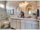 Well-lit bathroom featuring a dual vanity with granite counters, framed mirrors, and tiled shower and tub at 7432 Tahoe Basin Dr, Las Vegas, NV 89129