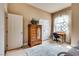 Bedroom featuring a daybed, desk, mirror armoire, and white closet doors creating a functional layout at 7432 Tahoe Basin Dr, Las Vegas, NV 89129