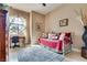 Bright bedroom with daybed, desk, sheer curtains, and neutral walls, creating a cozy space at 7432 Tahoe Basin Dr, Las Vegas, NV 89129