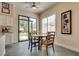 Eat-in kitchen area featuring a round wooden table, four chairs and access to the backyard at 7432 Tahoe Basin Dr, Las Vegas, NV 89129