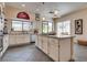 Well-lit kitchen with stainless steel appliances, granite countertops, and a center island with a cooktop at 7432 Tahoe Basin Dr, Las Vegas, NV 89129
