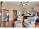 Large bedroom with hardwood floors, a king bed, two armchairs, and an ottoman at 7432 Tahoe Basin Dr, Las Vegas, NV 89129