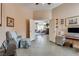 Entryway leading to office featuring neutral walls, tile floors, and comfortable chair and ottoman at 7432 Tahoe Basin Dr, Las Vegas, NV 89129