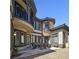 Outdoor patio with an elegant stone accent wall and outdoor dining set at 7695 Windy Meadow Ave, Las Vegas, NV 89178