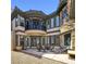 Exterior view of a backyard patio with stone accents and desert landscaping at 7695 Windy Meadow Ave, Las Vegas, NV 89178