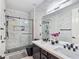 Modern bathroom featuring double sinks, elegant marble tiling, sleek fixtures, and glass shower enclosure for a luxurious feel at 7695 Windy Meadow Ave, Las Vegas, NV 89178