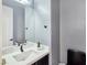 A clean bathroom with a modern sink, a large mirror, and sleek fixtures, designed for functionality at 7695 Windy Meadow Ave, Las Vegas, NV 89178