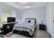 Cozy bedroom with wood floors, closet, and dresser with TV offering comfort and functionality at 7695 Windy Meadow Ave, Las Vegas, NV 89178