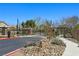 View of a gated community entrance with desert landscaping and controlled access at 7695 Windy Meadow Ave, Las Vegas, NV 89178