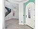 Bright foyer showcasing modern lighting, wood-look floors, and staircase in a contemporary design at 7695 Windy Meadow Ave, Las Vegas, NV 89178