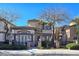 Charming stucco two-story home with stone accents and desert landscaping, enhancing its curb appeal at 7695 Windy Meadow Ave, Las Vegas, NV 89178