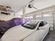 Organized two-car garage with ample storage space and two vehicles, one covered at 7695 Windy Meadow Ave, Las Vegas, NV 89178
