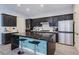 Modern kitchen featuring a black marble island and stainless steel appliances at 7695 Windy Meadow Ave, Las Vegas, NV 89178