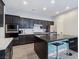 Contemporary kitchen with a black island, stainless steel appliances, and ample counter space at 7695 Windy Meadow Ave, Las Vegas, NV 89178