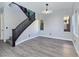 Modern living room with stylish staircase, recessed lighting, and wood-look floors for a sleek look at 7695 Windy Meadow Ave, Las Vegas, NV 89178