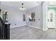 Bright living area showcasing modern lighting, wood-look floors, and a glimpse of the front entryway at 7695 Windy Meadow Ave, Las Vegas, NV 89178