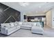 Stylish living room with modern lighting, open to the kitchen and dining areas at 7695 Windy Meadow Ave, Las Vegas, NV 89178