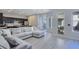 Open-concept living room leading to a modern kitchen and outdoor patio at 7695 Windy Meadow Ave, Las Vegas, NV 89178