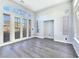 Open-concept living room with ample natural light, wood-look floors, and neutral color palette at 7695 Windy Meadow Ave, Las Vegas, NV 89178
