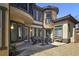 Beautiful outdoor patio with a stone accent wall and an outdoor dining set at 7695 Windy Meadow Ave, Las Vegas, NV 89178
