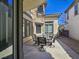 The patio featuring outdoor seating and a decorative turret, creating a cozy and inviting atmosphere at 7695 Windy Meadow Ave, Las Vegas, NV 89178