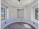 Bright sitting area with wood floors, recessed niche, modern lighting fixture, and large windows offering ample natural light at 7695 Windy Meadow Ave, Las Vegas, NV 89178