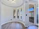 Bright sitting room with wood floors and access to a balcony offering a relaxing space and views of the neighborhood at 7695 Windy Meadow Ave, Las Vegas, NV 89178