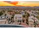 Beautiful aerial view of a neighborhood with palm trees and mountain backdrop at sunset at 784 Tossa De Mar Ave, Henderson, NV 89002